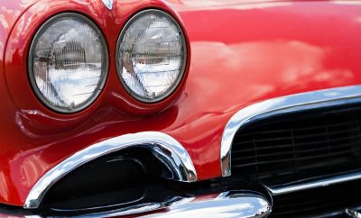a-closeup-of-the-headlights-and-front-bumper-on-a-vintage-american